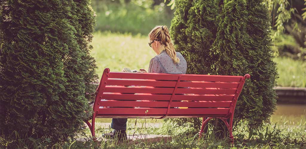 Mature woman at a park reading