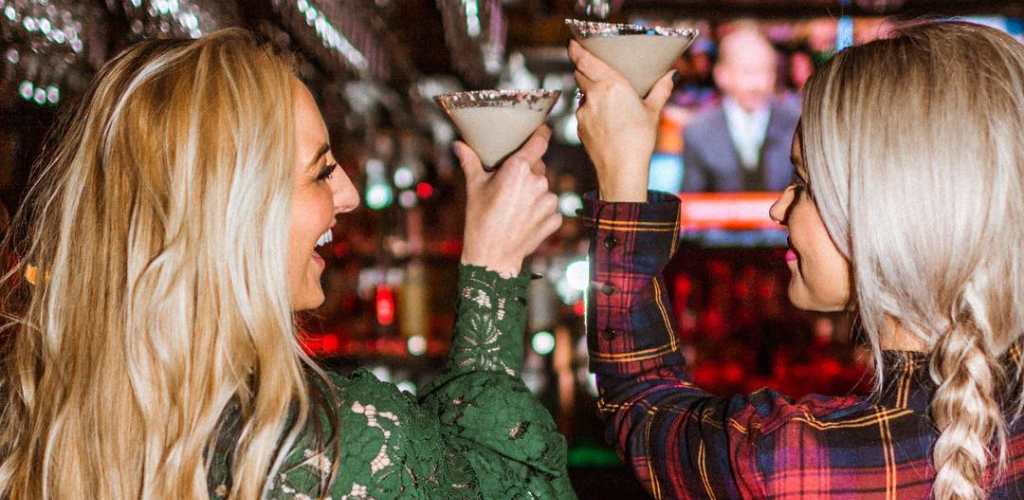 Lexington MILFs toasting cocktails at a bar in The Merrick Inn