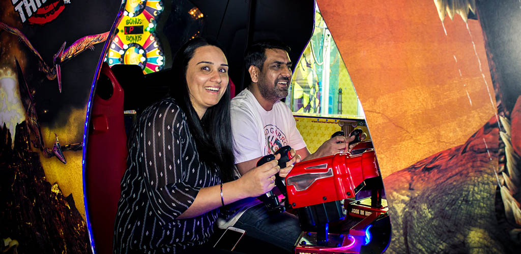 A couple playing in the arcade of The Spot