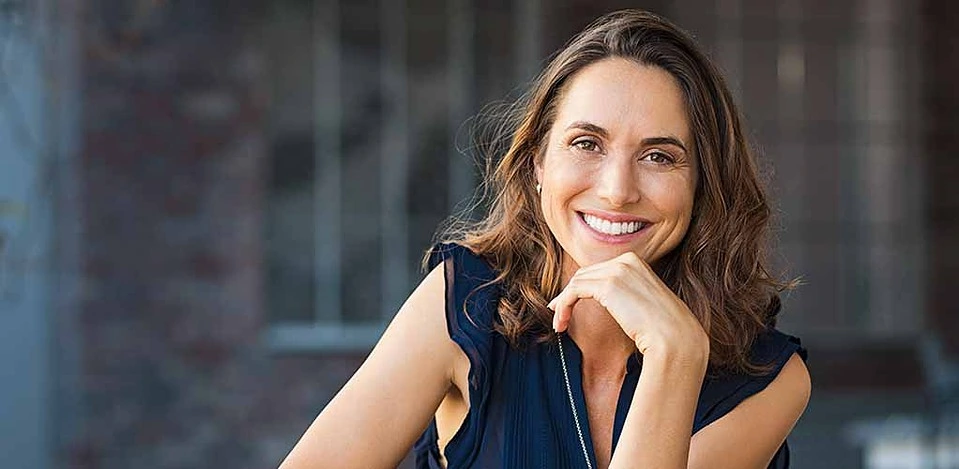 Happy mature woman at an outdoor cafe