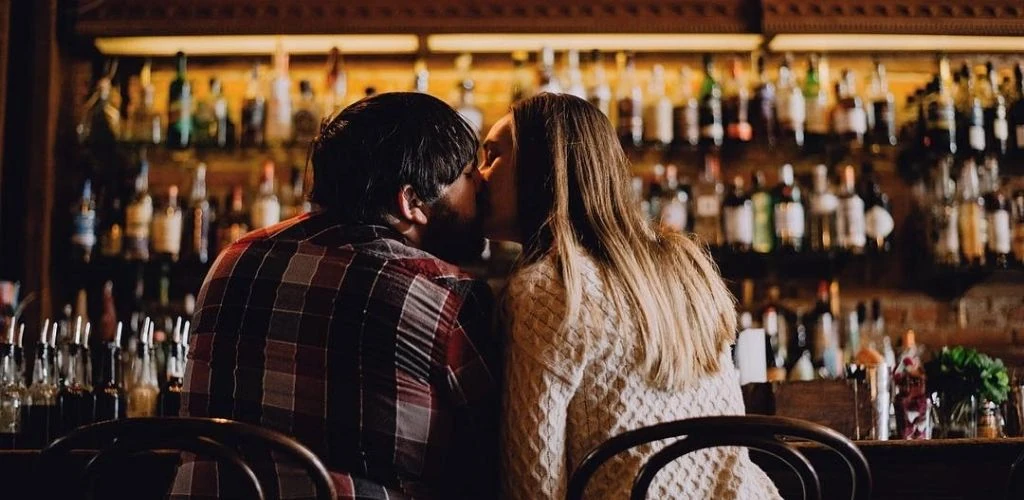 A man kissing a Detroit cougar on a date at The Sugar House