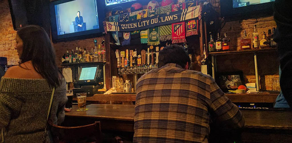 Mature woman at the bar of Courtyard Hooligans