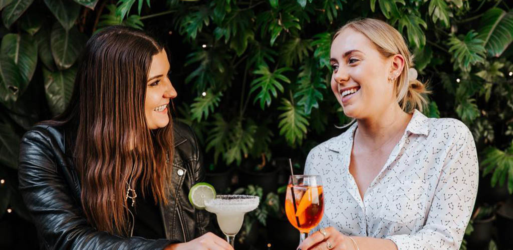 Friends enjoying cocktails at Story Bridge Hotel