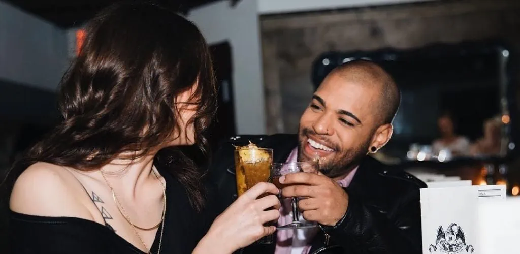 A Kansas City MILF toasting with her date by the bar at Manifesto