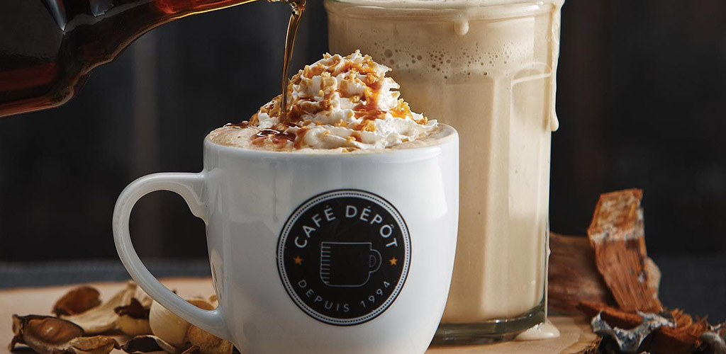 A latte topped with whipped cream from Cafe Depot