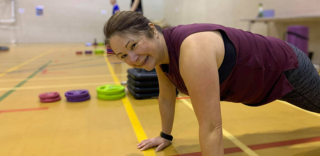 A fit, mature woman working out at Fife Sports and Leisure Trust