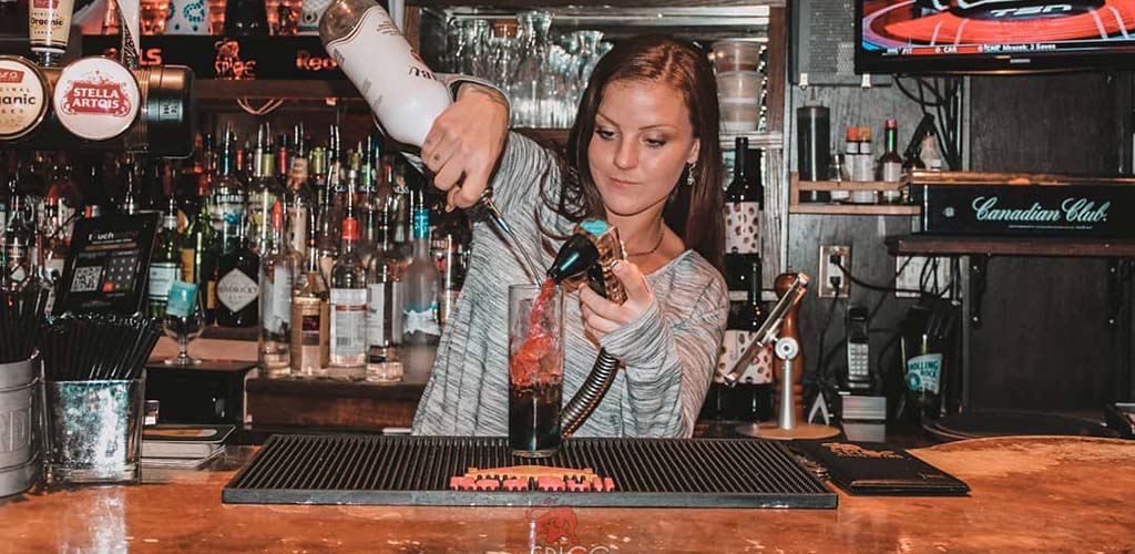 The bartender mixing a drink at Spice Lounge and Tapas