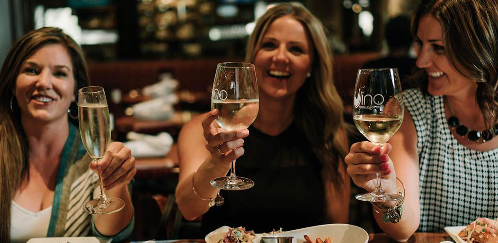 Cougars in Fresno enjoying white wine from Vino Grille & Spirits