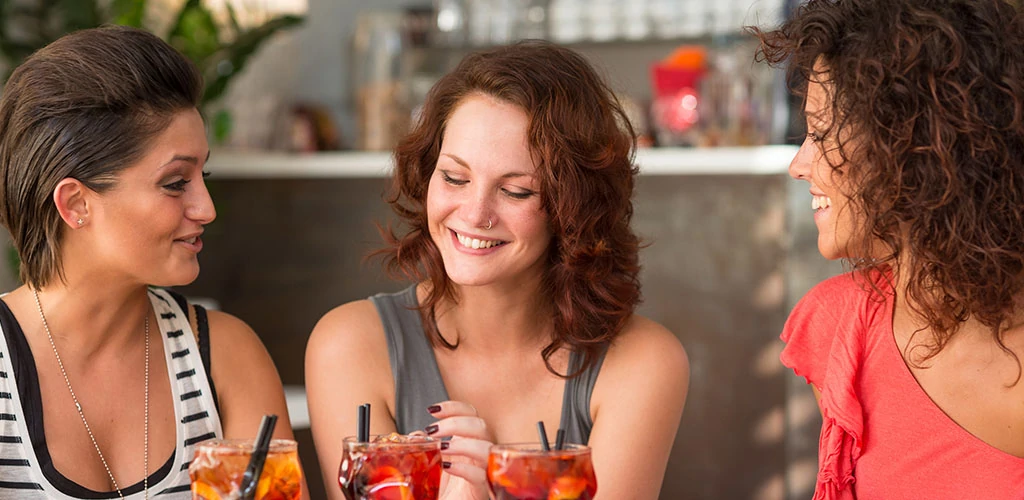 Women drinking cocktails at a bar