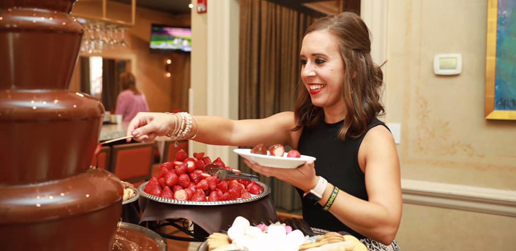 A woman with a serving of chocolate fondue at Mere Bulles Restaurant