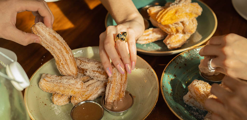 Ladies enjoying churros at Nada