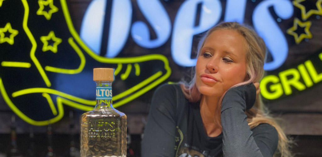 A hot woman with a bottle of tequila at Losers