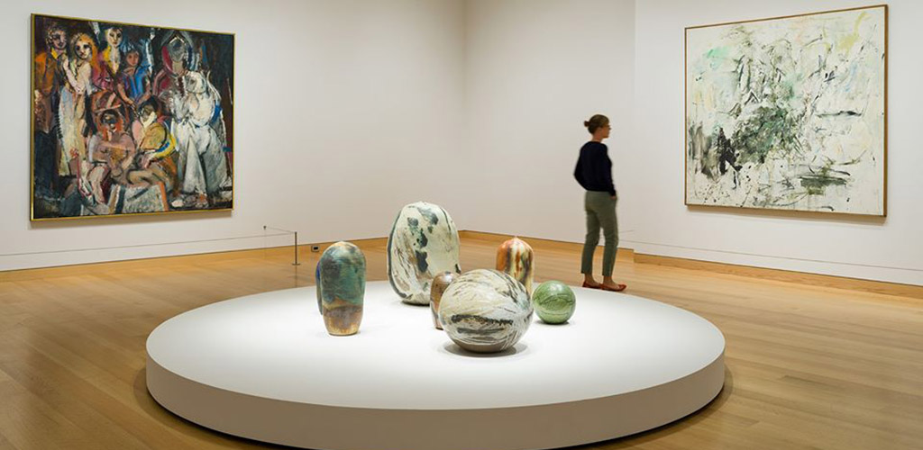 A woman admiring the artwork at the Museum of Fine Arts