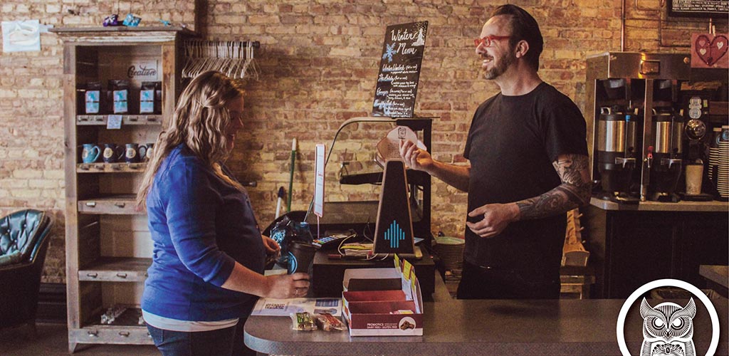 A woman ordering coffee at Blue Owl Coffee