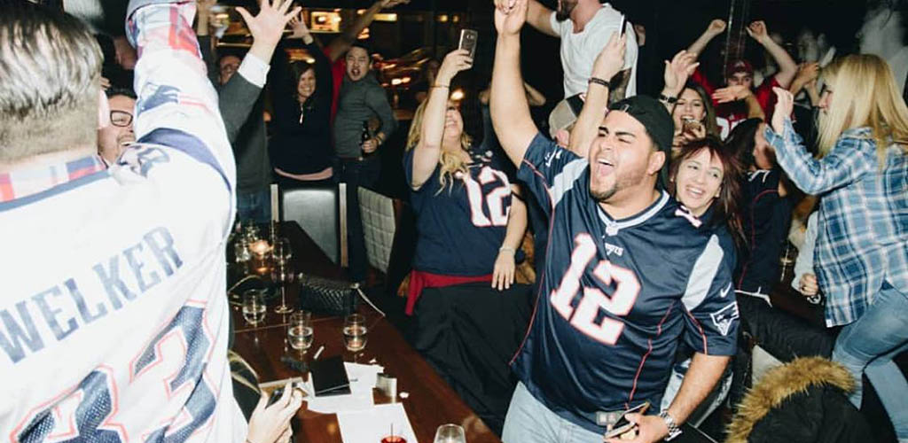 The lively crowd watching the game at Strip by Strega