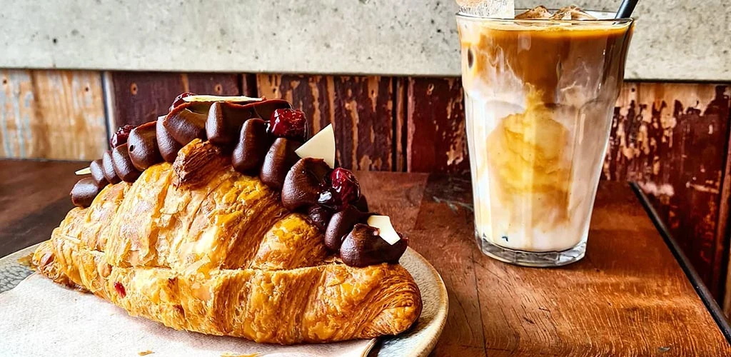 A croissant and iced coffee from Tamper Coffee