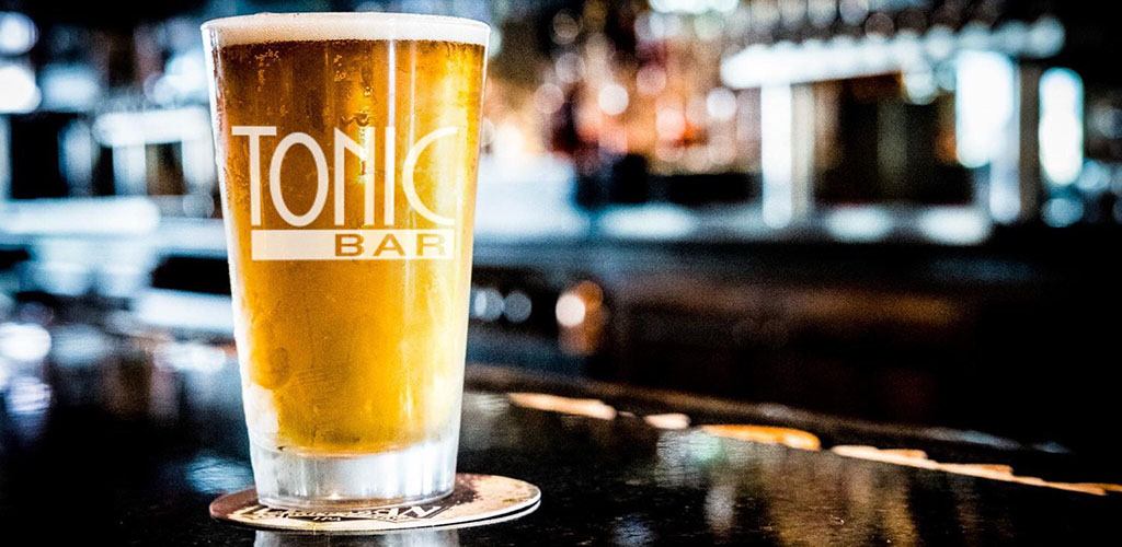 A tall glass of beer at Tonic Bar