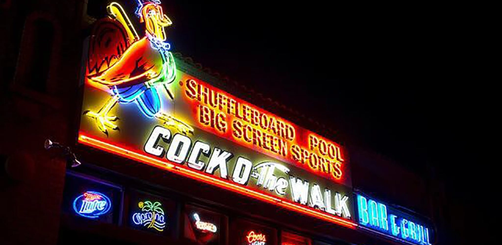 The neon sign of Cock O' the Walk Bar