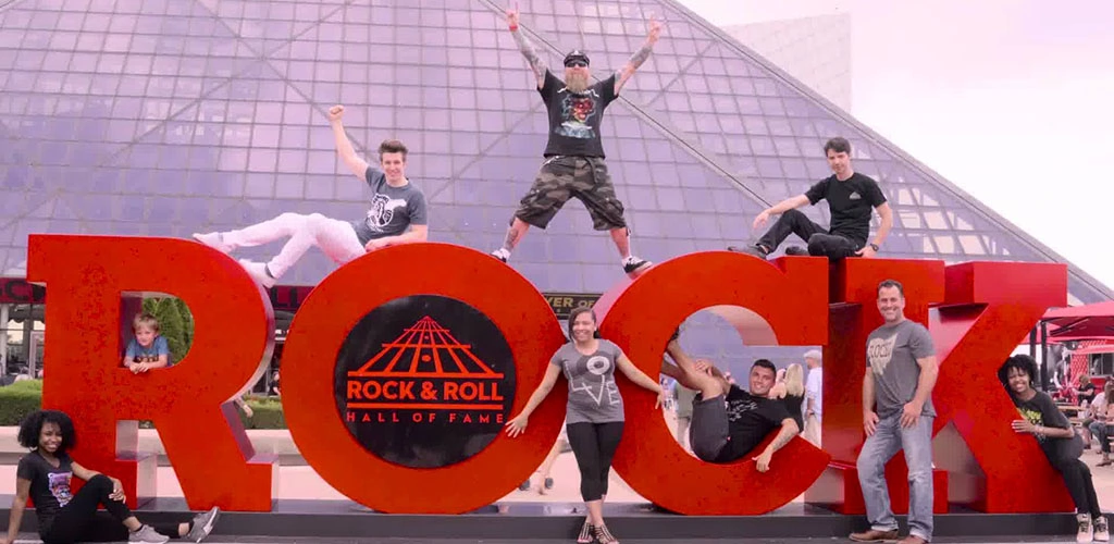 A group of friends posing in front of the Rock and Roll Hall of Fame