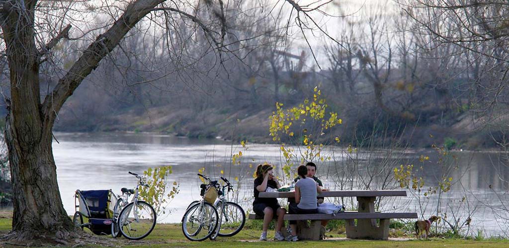 A group of friends resting after biking at Yokuts Park