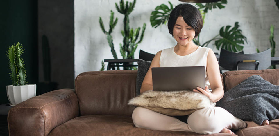 A beautiful Chinese cougar working on her laptop