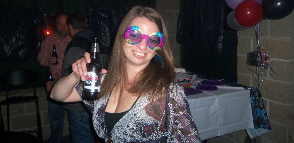 A woman with a beer and fun glasses at Last Chance