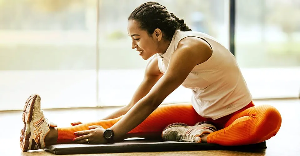 A woman stretching at the gym