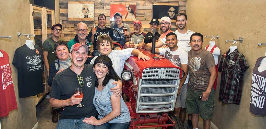 Friends taking a photo with the vehicle used for the Duke City Pedaler