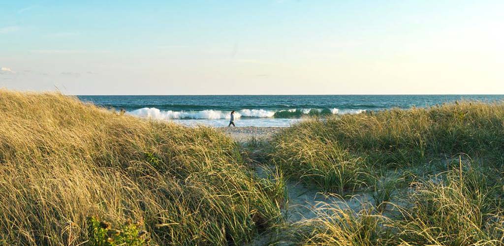 A woman jogging in Goosewing Beach