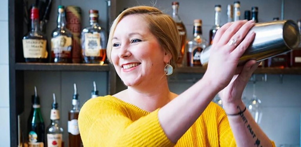 A woman mixing drinks at Portland Portland Hunt and Alpine Club