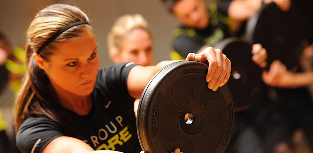 A woman in an intense workout at Pursue Fitness