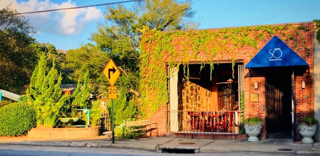 The rustic and green exterior of So Restaurant Bar