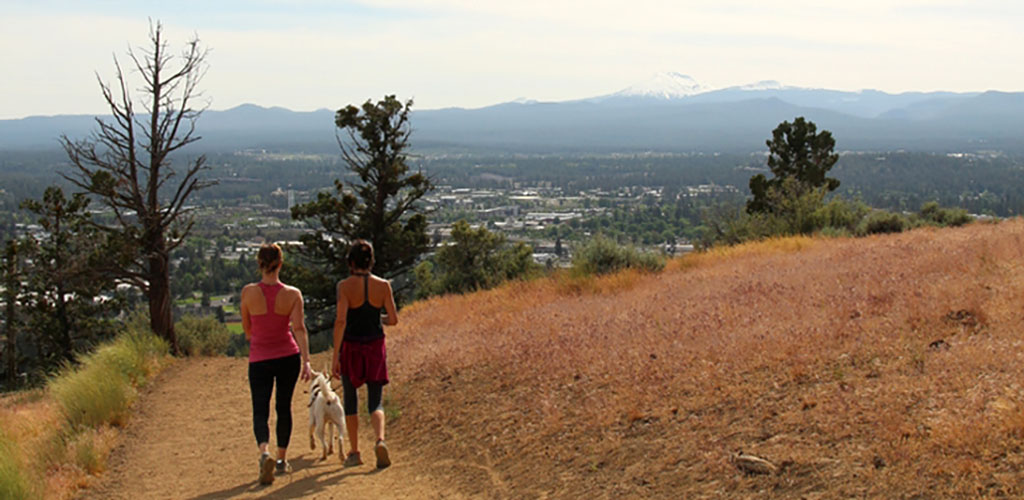 Women walking their dog at Pilot Butte State Park