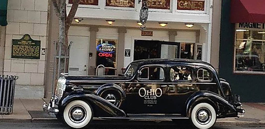 A vintage car parked outside of Ohio Club