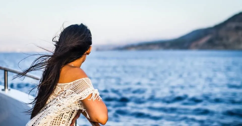 Woman looking at the ocean from a cruise ship