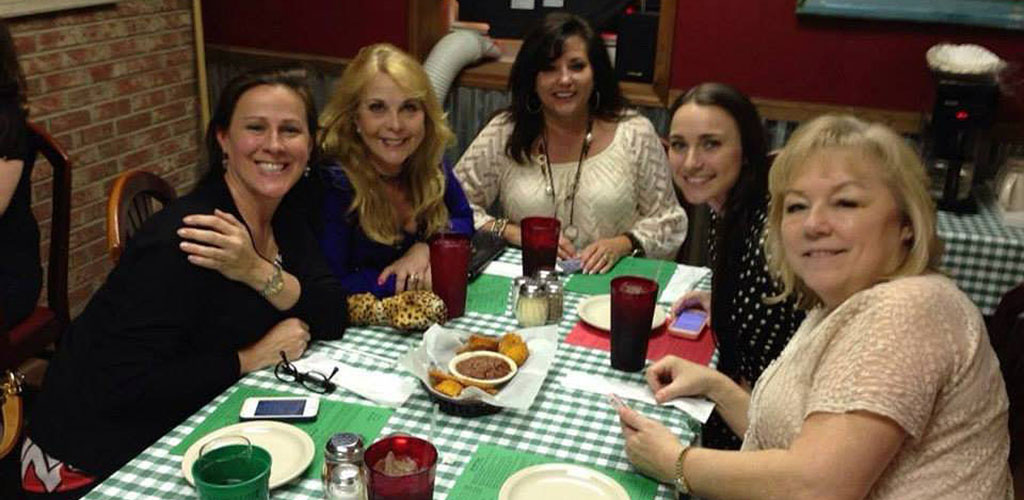 A group of friends having dinner at Angelo’s Eatery