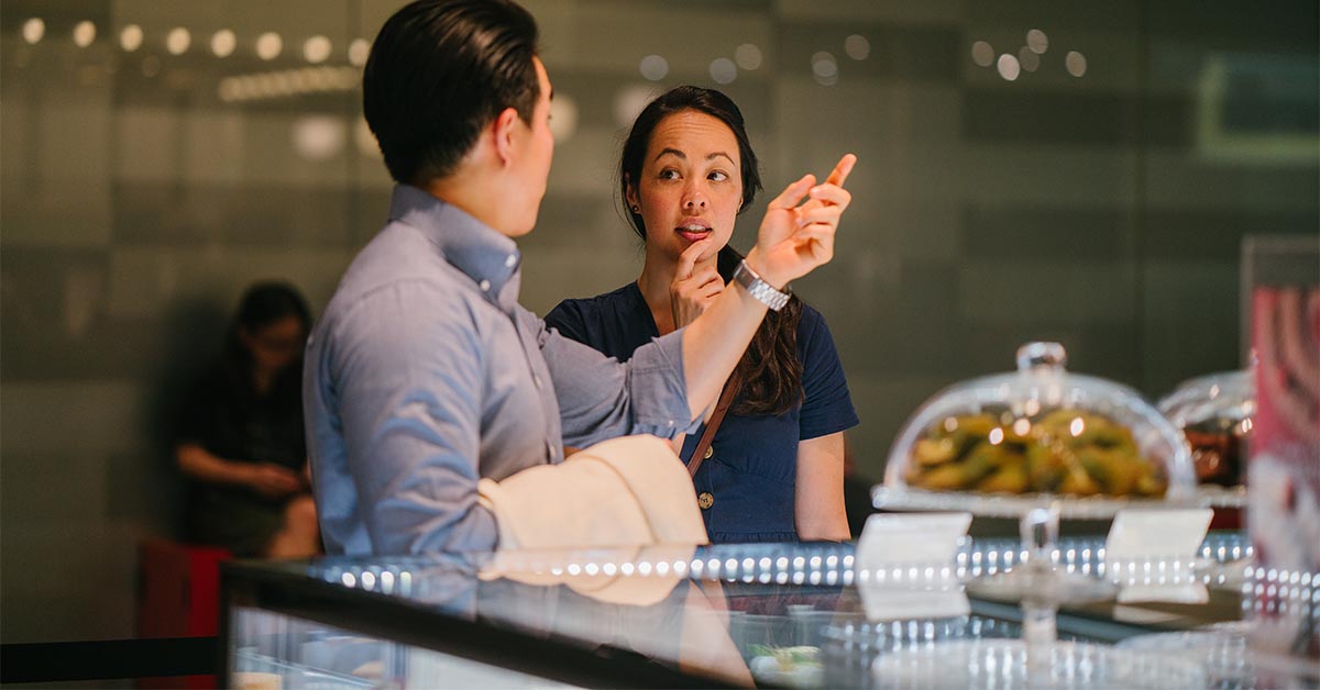 Man talking to a girl at a restaurant counter