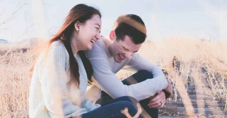 Couple laughing at the beginning of a conversation