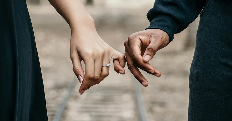 Couple in a serious relationship linking pinkies