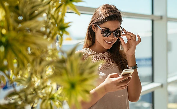 Woman in sunglasses texting