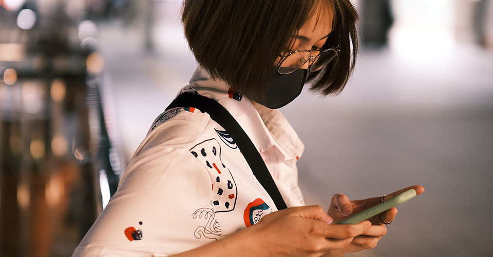 A woman in a mask using a free dating app