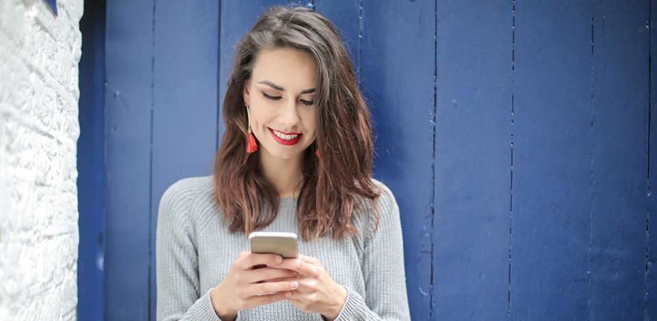 Young woman getting a text she likes