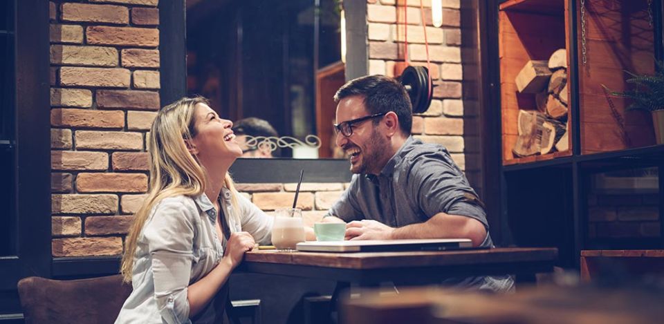 Man with glasses showing his pretty date how to be charming man