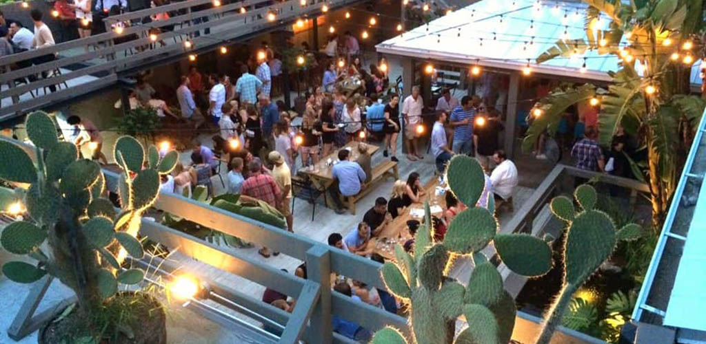 La Grange patio at night filled with lots of young people and string lights