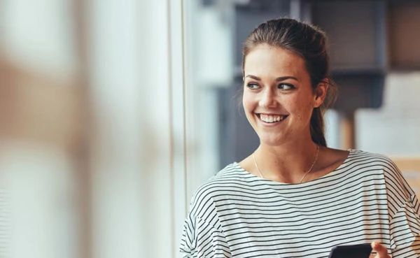 Woman looking out of a window while trying some good Virginia Beach dating apps