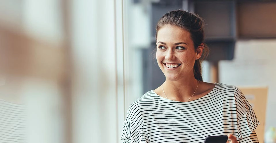 Woman looking out of a window while trying some good Virginia Beach dating apps