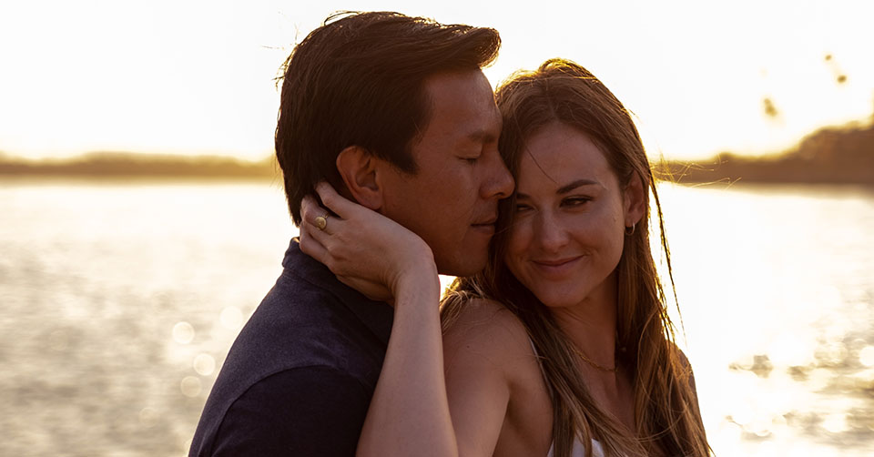 A couple in a waterfront restaurant