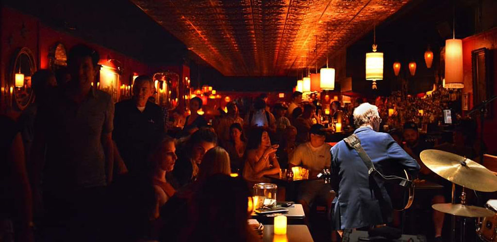 A jazz performance in the dimly lit Green Lady Lounge