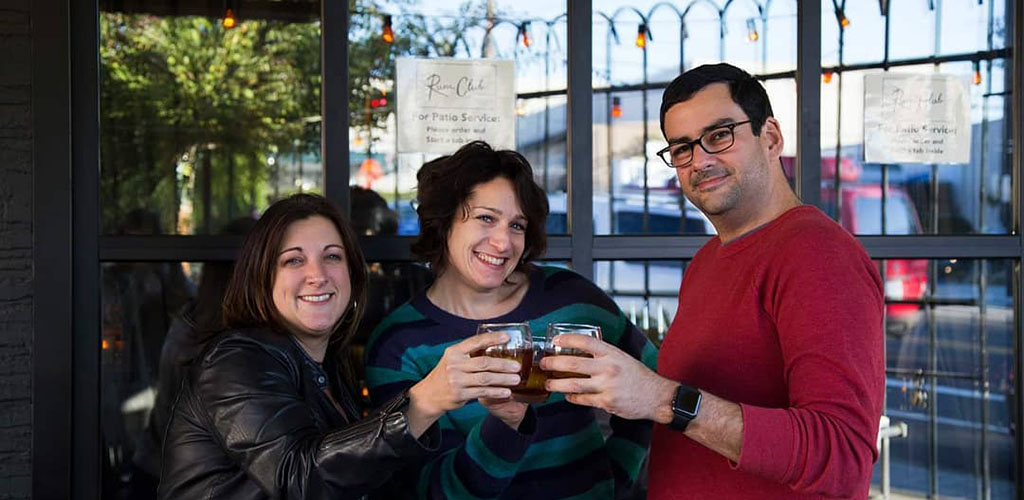 Friends toasting in front of Rum Club