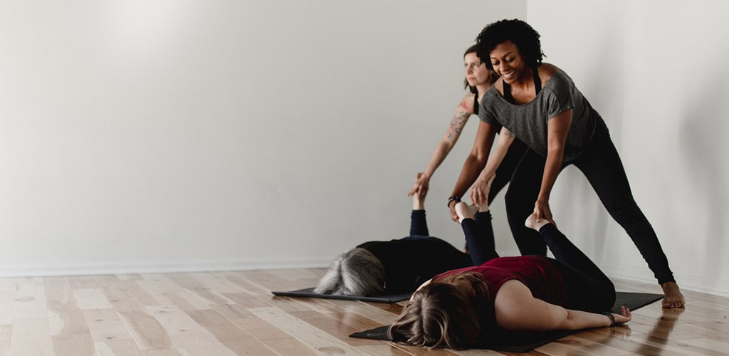 Women practicing yoga at Yoga on High